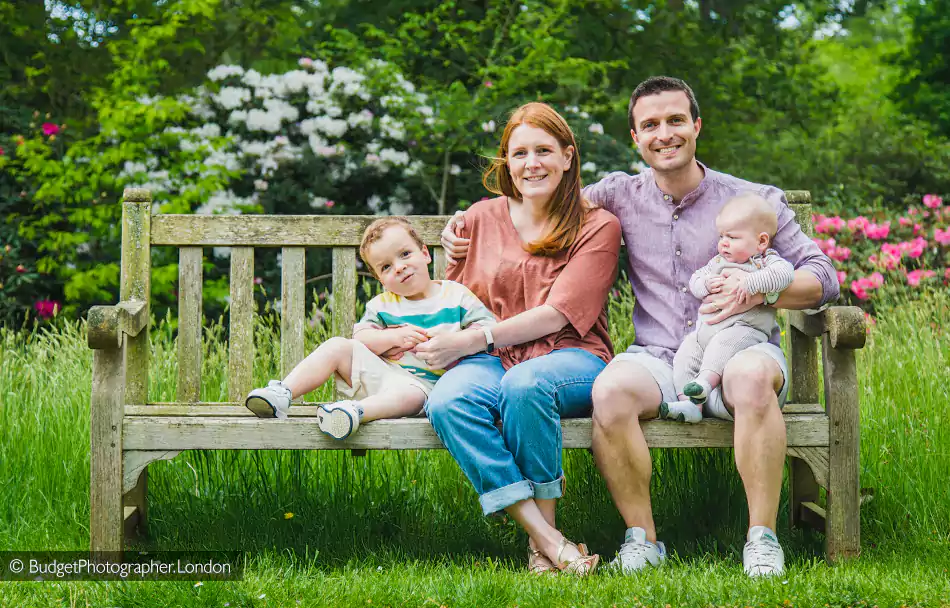 Family seated on a bench in the park